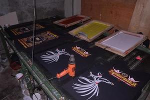 gresik, june, 2022 - manual screen printing studio with table and screen printing equipment photo