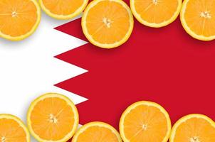 Bahrain flag  in citrus fruit slices horizontal frame photo