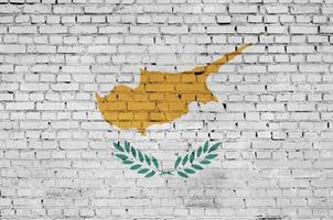 Cyprus flag is painted onto an old brick wall photo