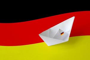 Germany flag depicted on paper origami ship closeup. Handmade arts concept photo