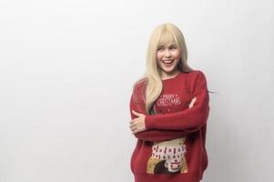 Portrait of happy Caucasian young woman in Christmas sweater over white background photo