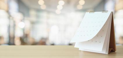 desk calendar on table with blurred bokeh background appointment and business meeting concept photo