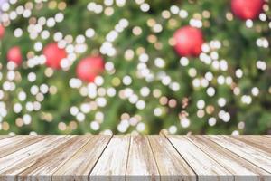 Empty wood table top with blur Christmas tree with bokeh light background photo