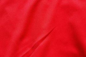 Fondo de textura de jersey de camiseta de fútbol de tela de ropa deportiva roja foto