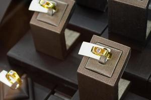 Gold jewelry diamond rings show in luxury retail store display showcase photo