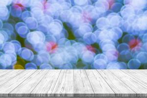 Empty wood table top with blur Christmas tree with bokeh light background photo