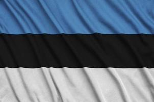 Estonia flag  is depicted on a sports cloth fabric with many folds. Sport team banner photo