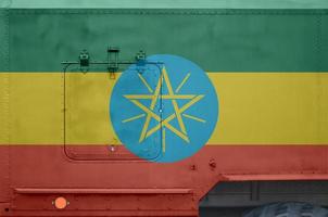 Ethiopia flag depicted on side part of military armored truck closeup. Army forces conceptual background photo