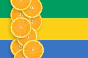 Gabon flag and citrus fruit slices vertical row photo