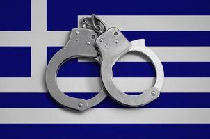 Greece flag  and police handcuffs. The concept of observance of the law in the country and protection from crime photo