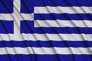 Greece flag  is depicted on a sports cloth fabric with many folds. Sport team banner photo
