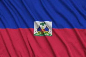 Haiti flag  is depicted on a sports cloth fabric with many folds. Sport team banner photo