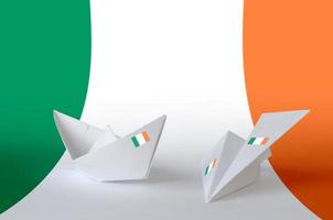 Ireland flag depicted on paper origami airplane and boat. Handmade arts concept photo