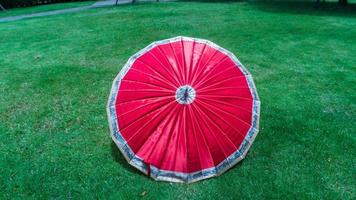 red umbrella on the grass photo