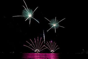 fireworks celebration over sea in pattaya beach photo