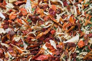 Dried spices, sun-dried tomatoes, dried carrots, Basil and Provencal herbs. Close-up Selective focus. photo