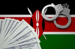 Kenya flag  with handcuffs and a bundle of dollars. The concept of illegal banking operations in US currency photo