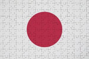 Japan flag  is depicted on a folded puzzle photo