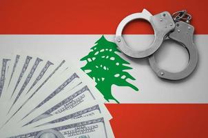 bandera de líbano con esposas y un paquete de dólares. el concepto de operaciones bancarias ilegales en moneda estadounidense foto