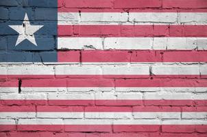 Liberia flag is painted onto an old brick wall photo