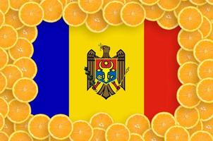 Moldova flag  in fresh citrus fruit slices frame photo