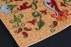 A closeup shot of national ornaments and patterns of Central Asia on a piece of fabric photo