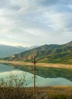 A vertical shot of the mountains and a reservoir in Central Asia photo