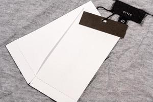 A closeup shot of a blank clothing tag on a string for a price label on a cloth photo