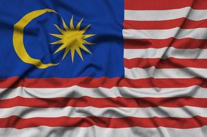 Malaysia flag  is depicted on a sports cloth fabric with many folds. Sport team banner photo