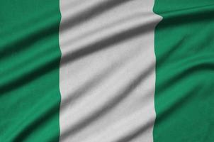Nigeria flag  is depicted on a sports cloth fabric with many folds. Sport team banner photo