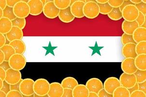 Syria flag  in fresh citrus fruit slices frame photo