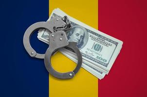 Chad flag  with handcuffs and a bundle of dollars. Currency corruption in the country. Financial crimes photo