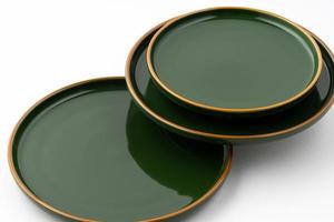 A set of green ceramic plates on a white background photo