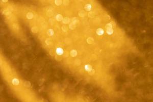 Abstract gold glitter light blur flash glitter defocus background photo