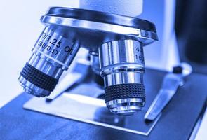 Closeup lens of a modern microscope in a research lab. Selective focus photo