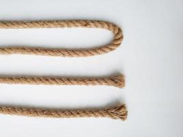 Rough natural rope strings on white background photo