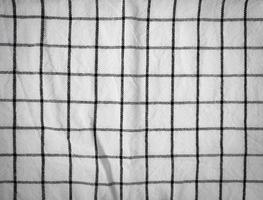 Checkered tablecloth fabric or towel. Black with white square pattern photo