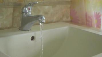 Water running from faucet into sink video