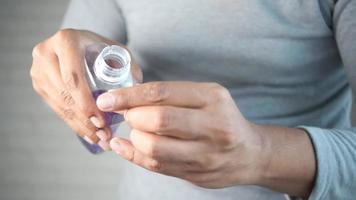 Adult pours purple liquid into measuring cap video