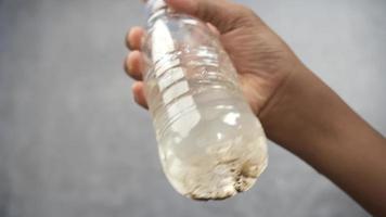 Sediment settles at bottom of clear plastic water bottle video