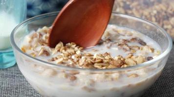 Pouring granola oats into bowl of milk video