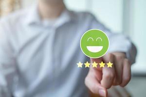 Feedback rating and service review. Customer experience, Mental health assessment, World mental health day, Think positive, Emotion, Satisfaction. Hand point to green happy face and 5 star. photo