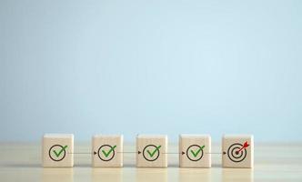 Checklist, Task list, Survey and assessment, Quality Control, Goals achievement and business success. Elections and Voting, Vote, to do list. Complete with Check mark on wooden block to dartboard. photo