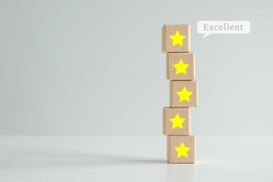 Evaluation, Satisfaction, Feedback, Review concept. Five star on stack of wooden block with Excellent on speech bubble. The best excellent business services rating customer experience. photo