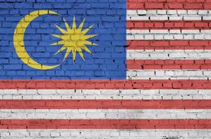 Malaysia flag is painted onto an old brick wall photo