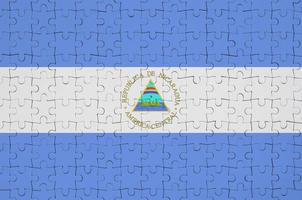 Nicaragua flag  is depicted on a folded puzzle photo