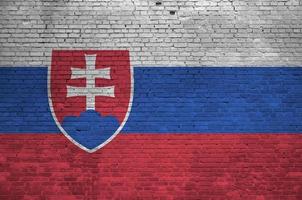 Slovakia flag depicted in paint colors on old brick wall. Textured banner on big brick wall masonry background photo