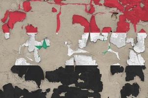 Syria flag depicted in paint colors on old obsolete messy concrete wall closeup. Textured banner on rough background photo