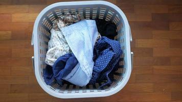 Overhead panning view of a laundry basket with dirty clothes video