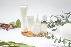 moisturizing cream bottle over leaf background studio, packing and skincare beauty concept photo